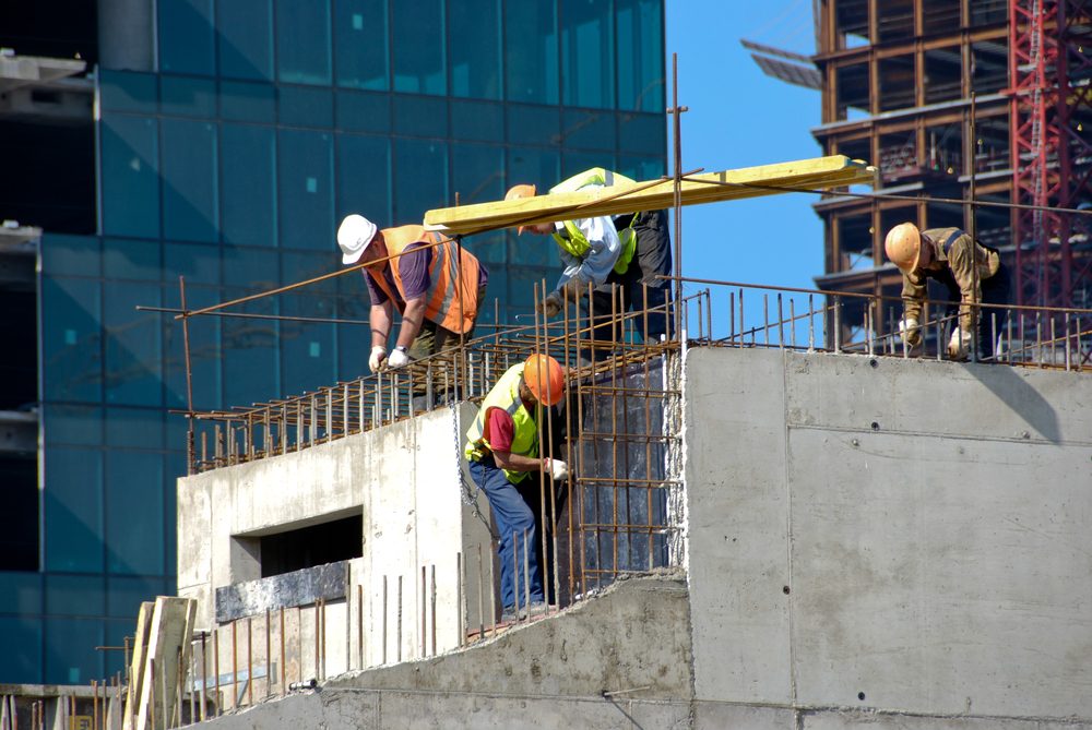 Builders work on skyscraper construction