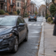 Boston hit-and-run injury claim scene on a city street with a damaged vehicle and a witness