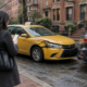 Boston taxi accident injury claim scene with an unbranded cab and passenger documenting vehicle details